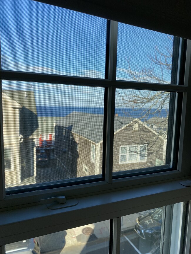 Peek of Sandy Bay from bedroom - 36 Main St