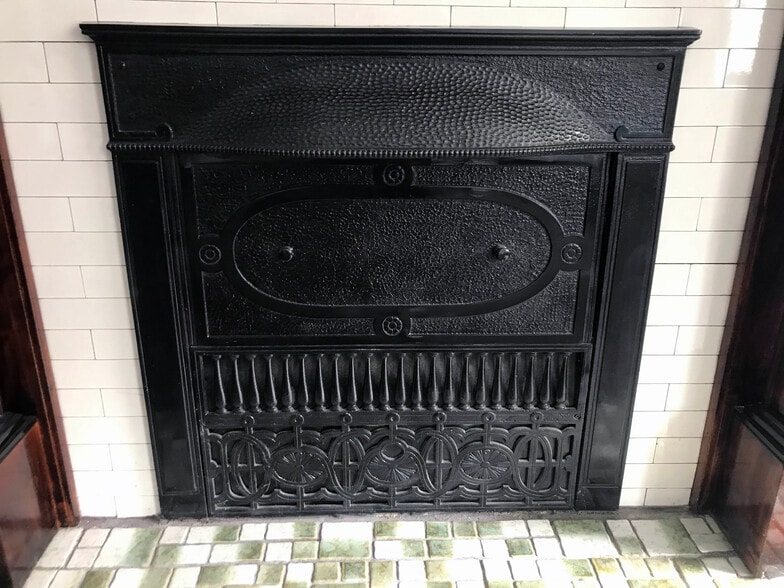 Beautiful historic details on iron fireplace cover - 4125 Juniata St