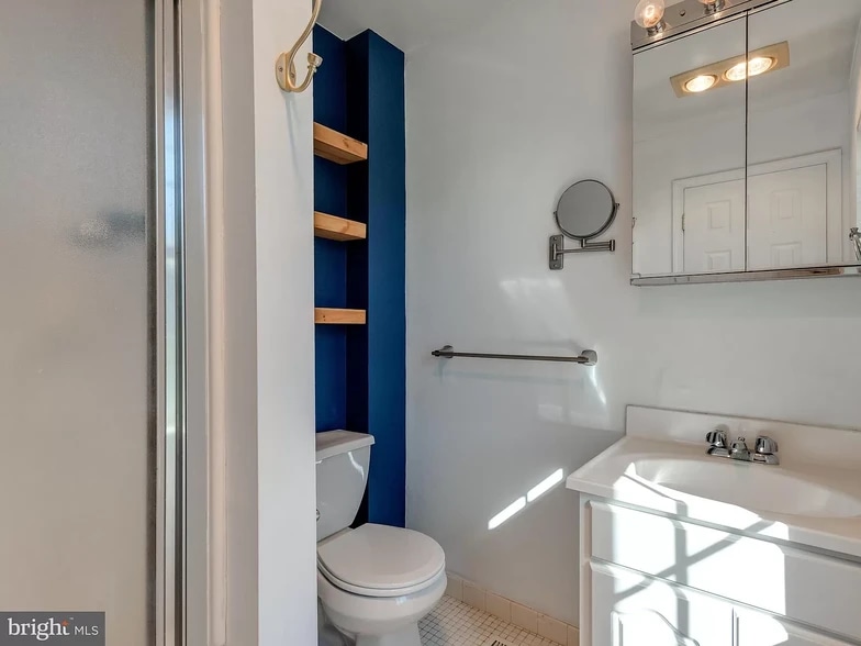 The master bathroom has a stand up shower as well as storage shelves - 232 Carlyn Ct
