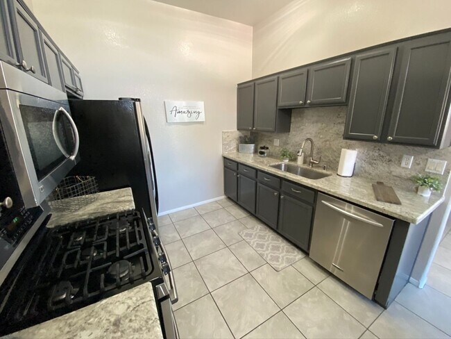 Building Photo - BEAUTIFUL CONDO IN A GATED COMMUNITY FEATURING PLANTATION SHUTTERS, TILE FLOORING AND NEW PAINT T...