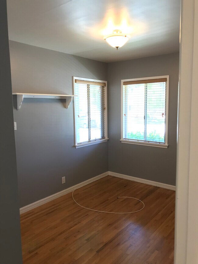Third, small bedroom at front of house has original oak flooring and original closet. - 14911 Fonthill Ave