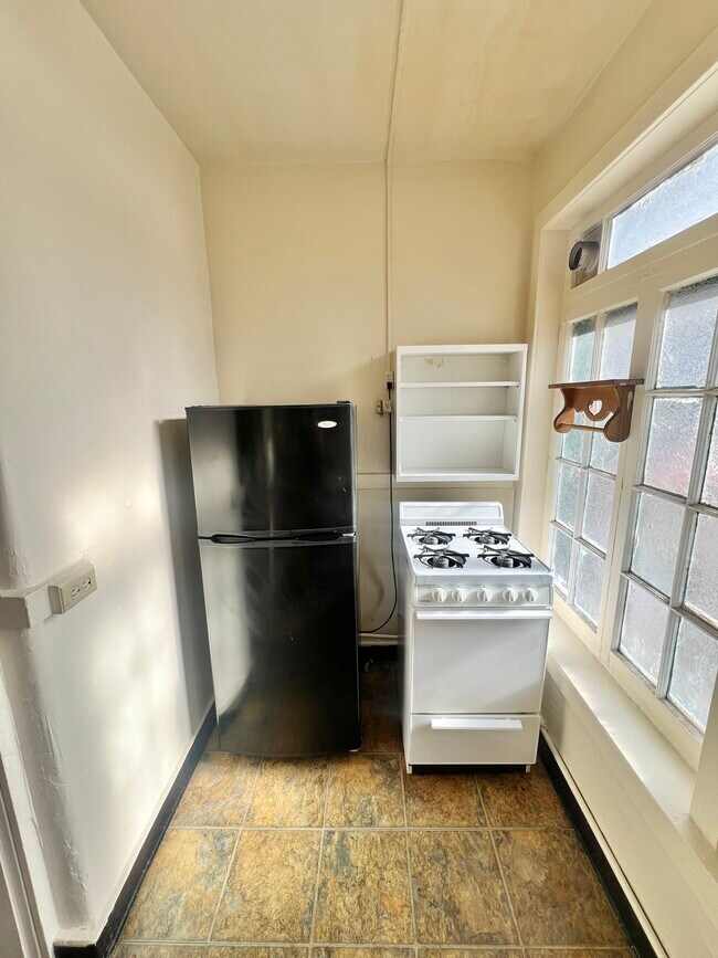 Experience efficient living with this thoughtfully designed kitchen area. - Cross Apartments