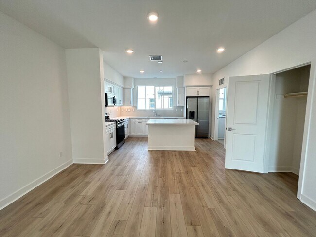 Building Photo - Gorgeous, 3 level townhome, featuring 2 car garage central Air, and in Unit laundry.