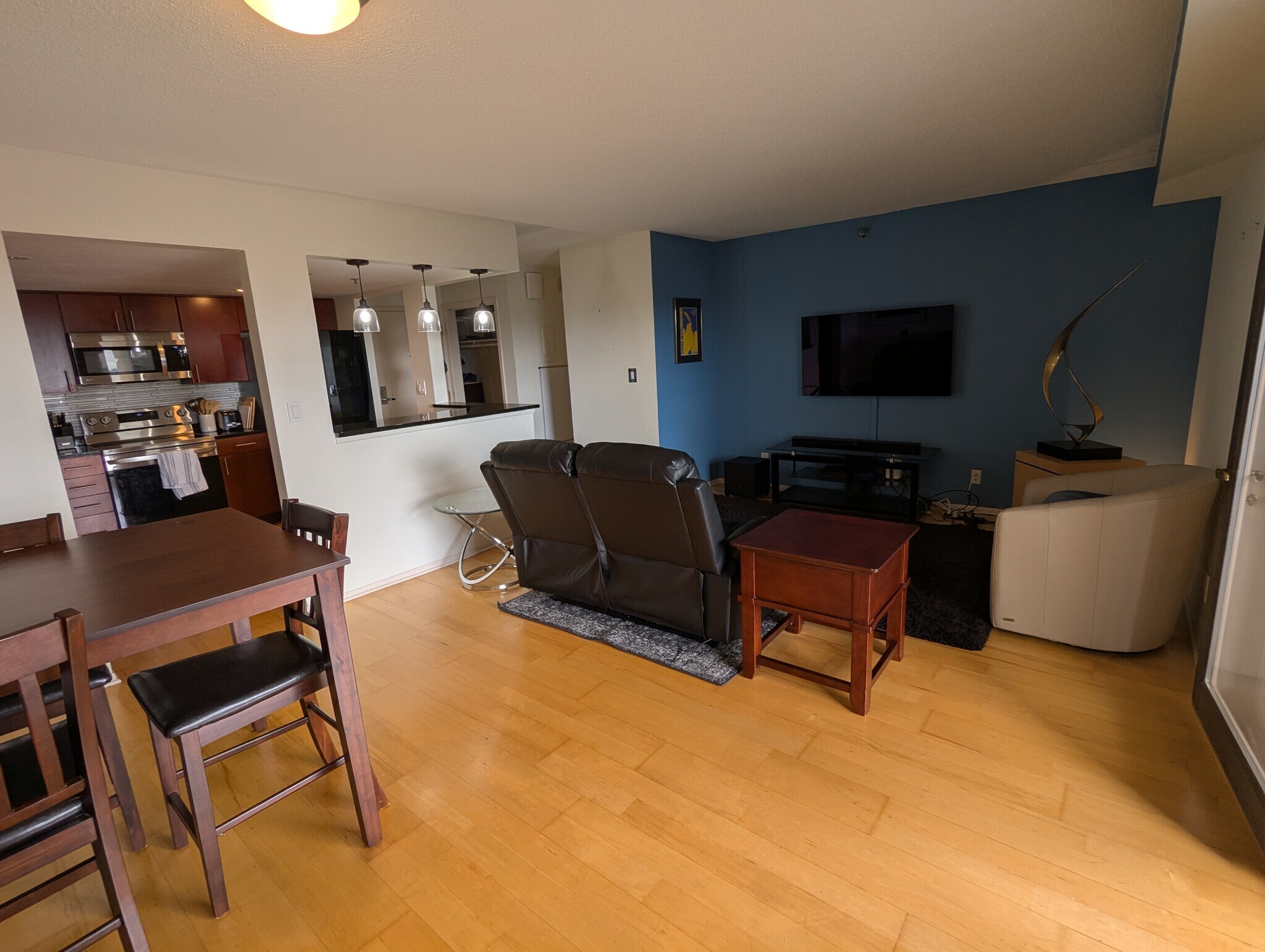 Large living room with surround sound and entertainment system. - 110 1st Ave NE