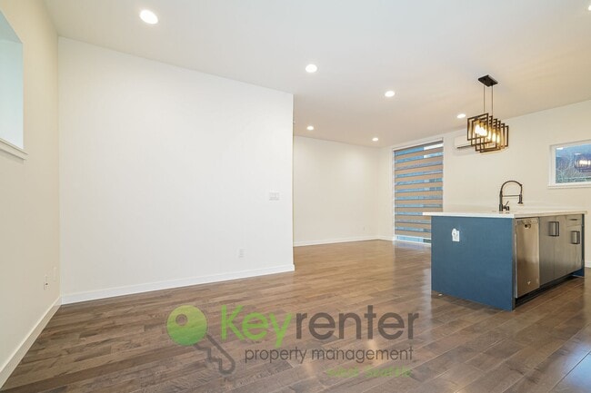 Building Photo - Rooftop Living with Open Concept Design and Parking Included