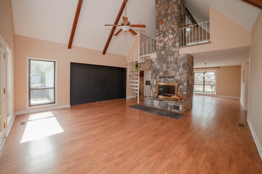 Versatile open space with dramatic stone fireplace. - 6812 Uppingham Rd