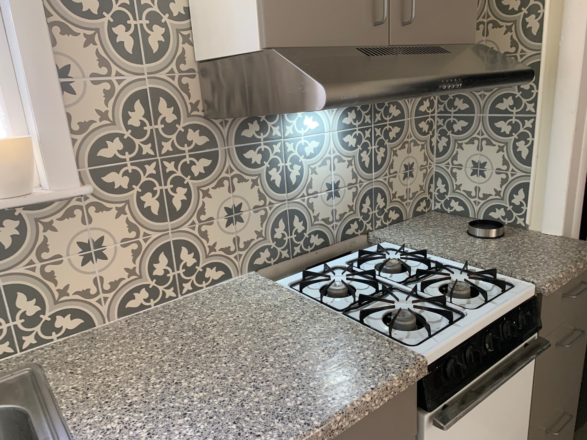 Small gas stove with vented stainless steel hood. - 22 Lyon St