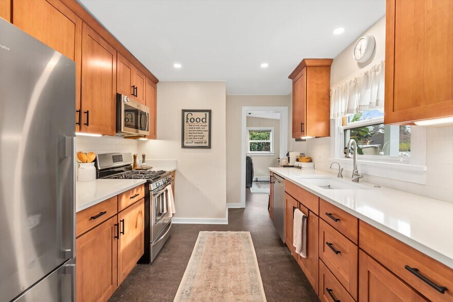 Updated kitchen with stainless steel appliances, gas range, instant-hot water - 8042 Earl Ave NW