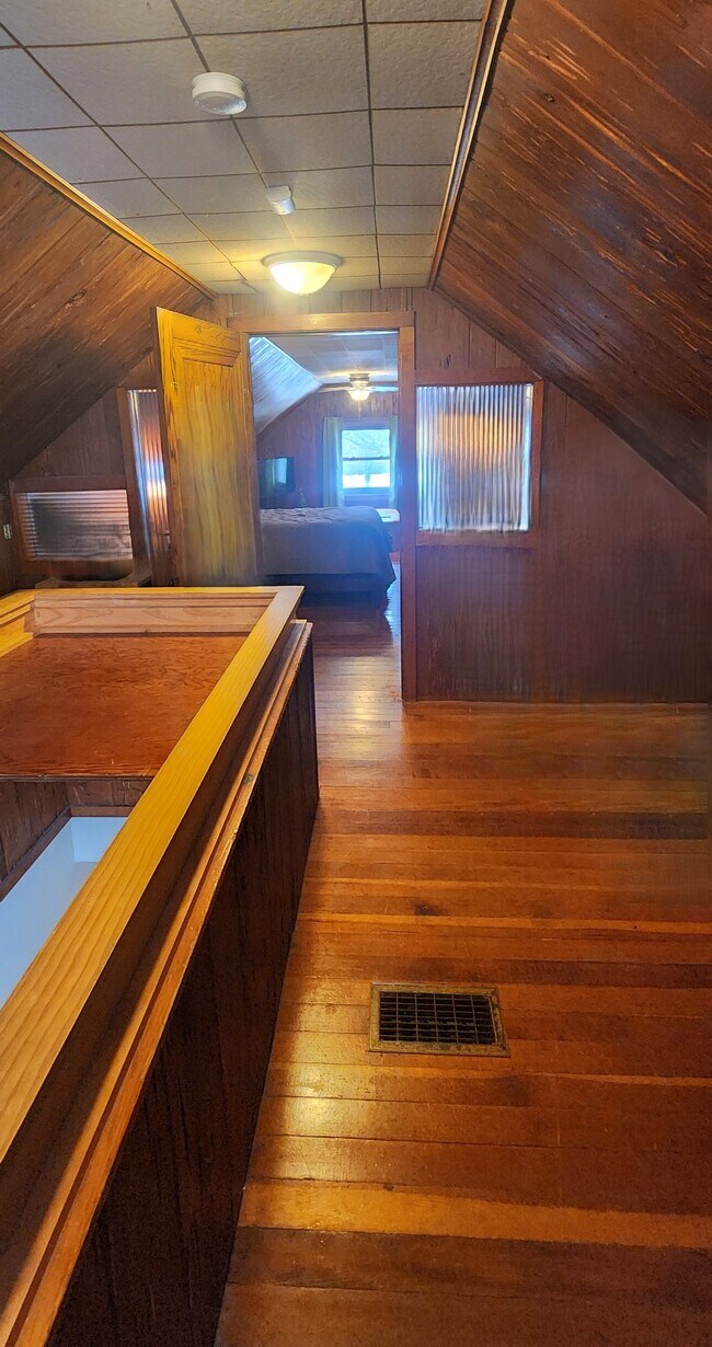 Expansive upper-level space showcasing hardwood floors and substantial usable square footage. - 2923 Arthur St NE