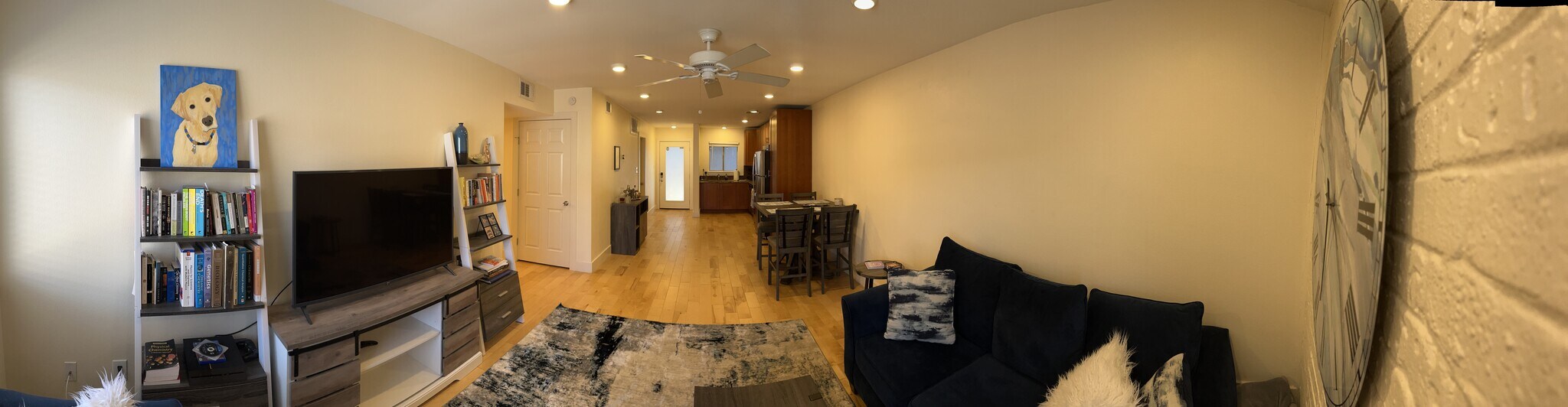 Wide angle view of the living room facing towards the kitchen. The visible closet holds the w/d. - 909 Reinli St
