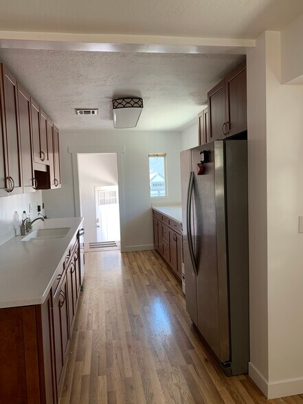 Long kitchen with lots of cabinets and counter space. Stainless steel appliances! - 544 Wilmington Ave
