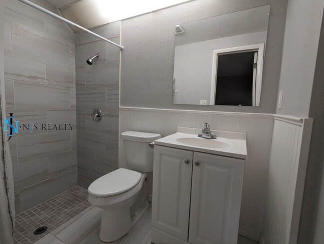 Building Photo - 2/2/1 with  RENOVATED baths & kitchen, fenced yard, NEW lvp flooring and a OVERSIZED lanai!