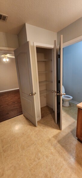 View from Master bathroom of the master bedroom, towel closet, and private toilet stall - 2318 Tall Oak Dr