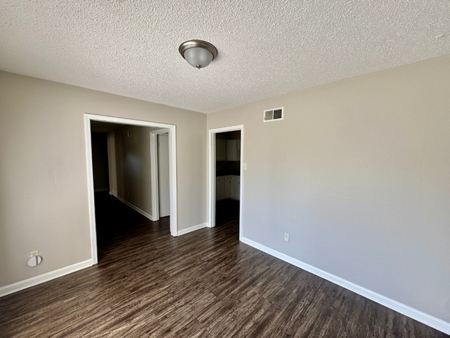Building Photo - Charming 3BR/2BA Near Southwind | Soaring Vaulted Ceilings, Brick Fireplace & Fenced Yard