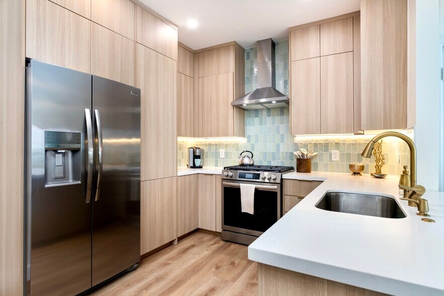 Stainless steel refrigerator with ice and water in the door, gas range with air fry, slow cook, and - 2221 Ocean Ave