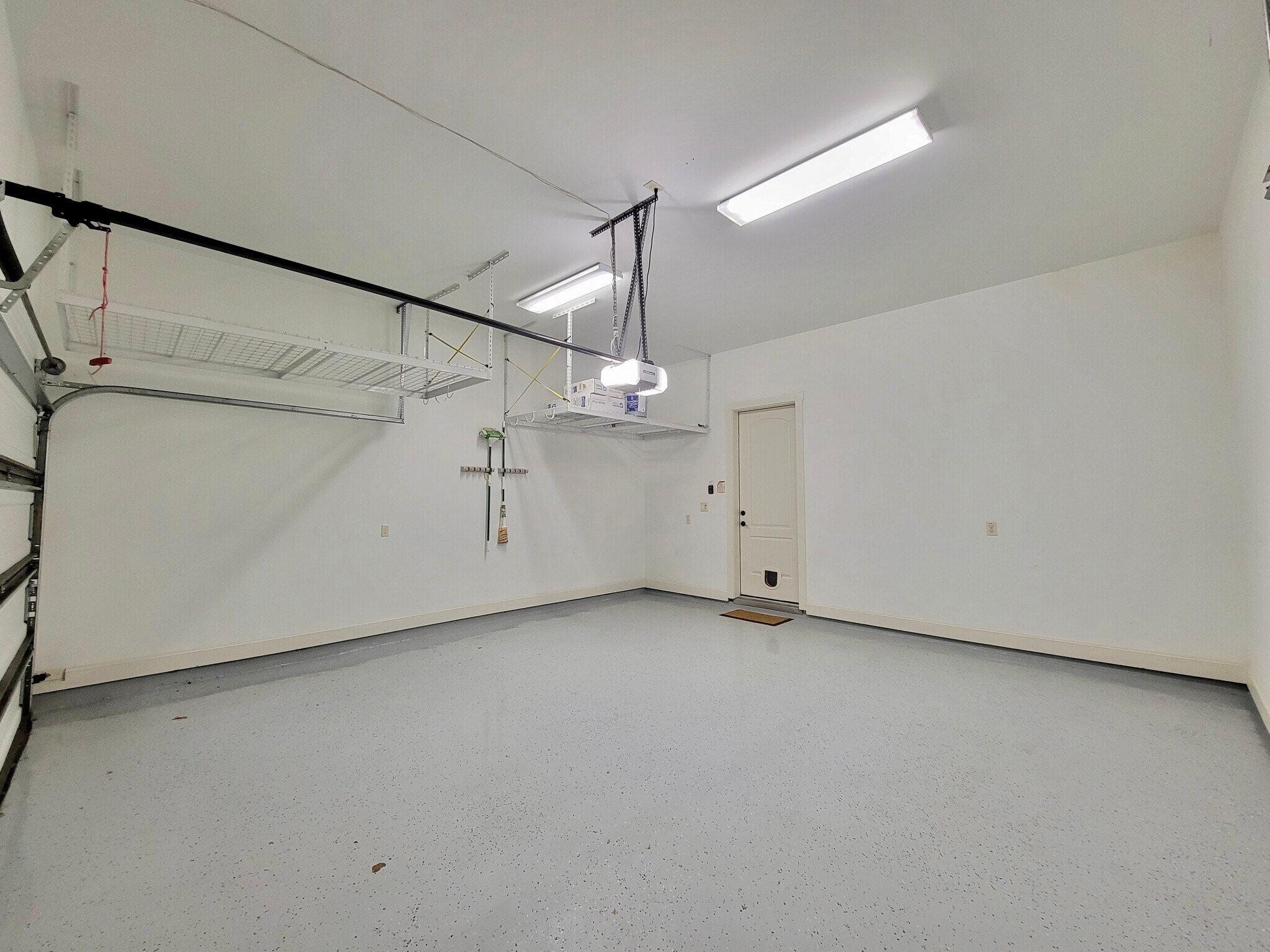 Roomy insulated garage with overhead storage and epoxy floor. Wifi connected garage door. - 6121 Hamman St