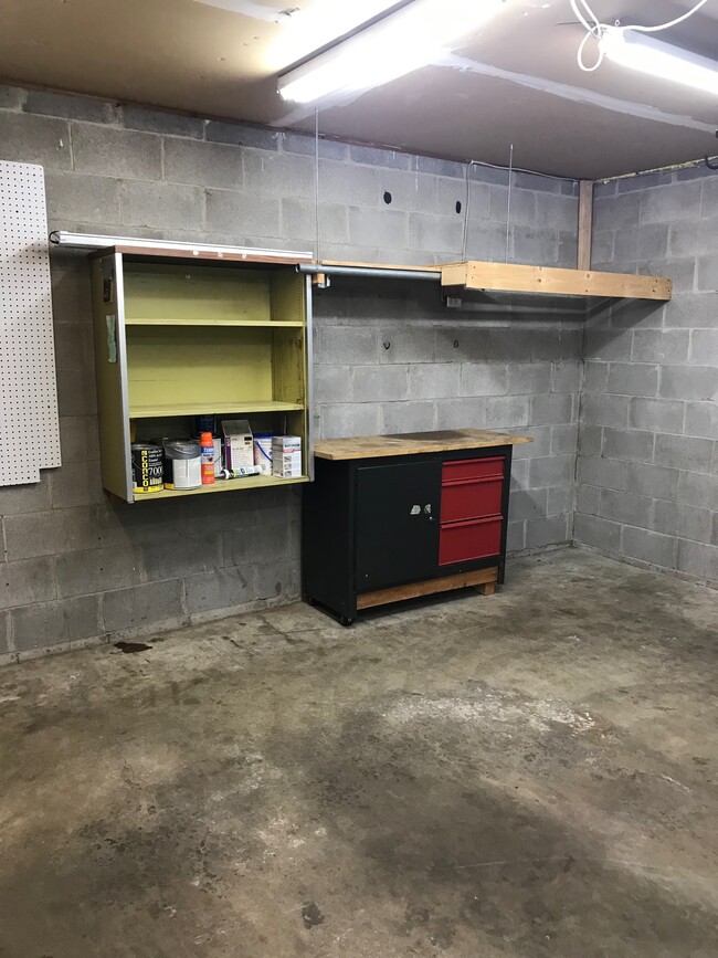 Shelving and workbench in garage - 8524 S Maplebrook Circle