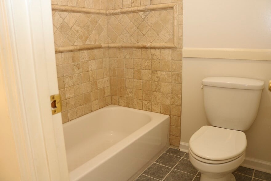 Bathroom 1 with custom tile work and upgraded faucets. - 7005 Sand Wedge Cir