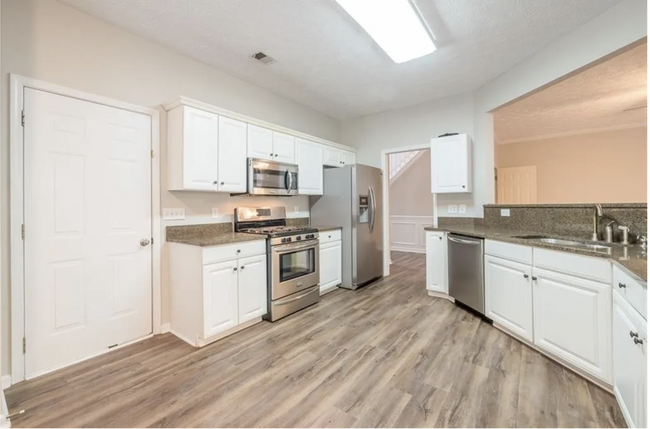 Kitchen and Garage entrance *Renter must provide their own Fridge - 235 Colony Center Dr