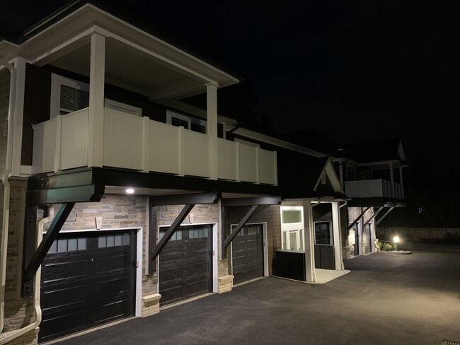 Resident garages at night - 16600 Boones Ferry Rd