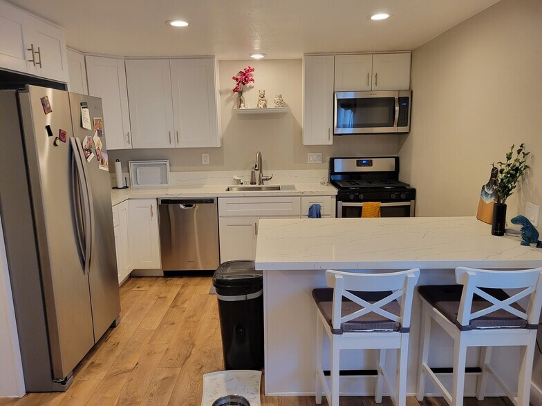 Kitchen island offers additional cooking space and seating. - 3673 Cherokee Ave