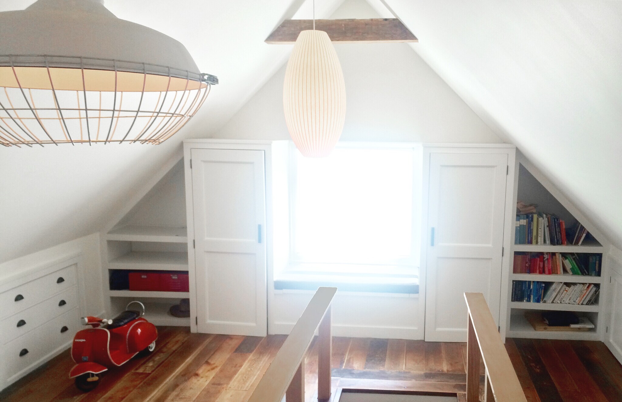 Upstairs master hangout space or master bedroom. Large window seat (and storage) flanked by tall closets and built in bookshelves. Authentic George Nelson MCM lamp fixtures. - 2635 NE 30th Ave