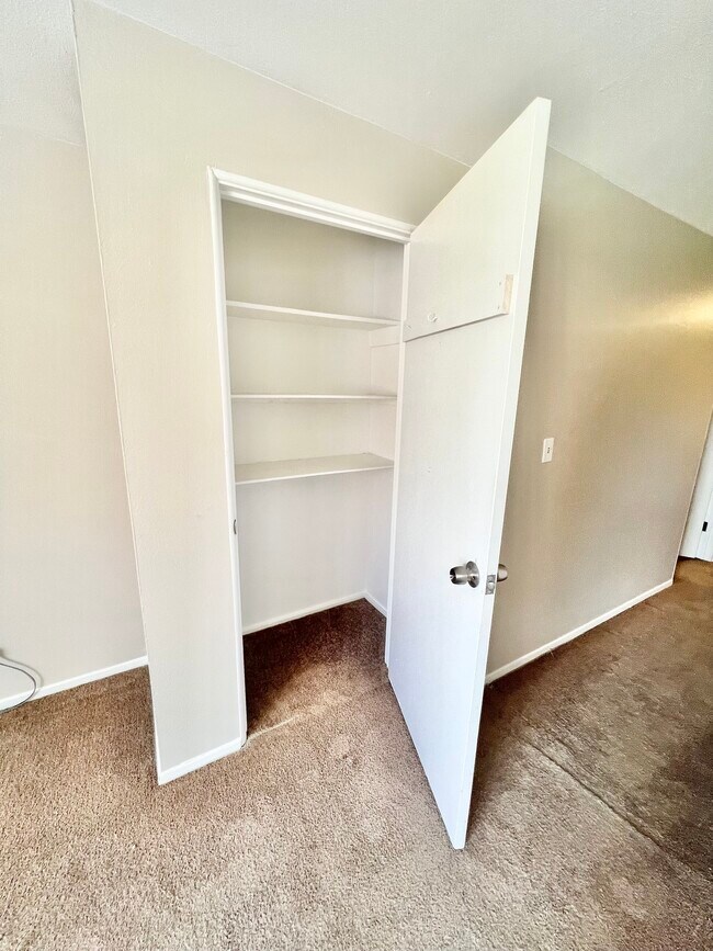 Explore the ample storage space with this elegant closet design. - Westland Apartments