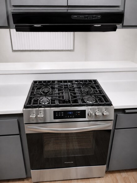 Newer stainless steel gas range with modern controls and multiple burners. - 339 E Taft Ave
