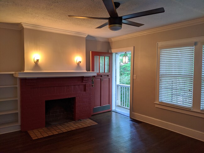 living room non-functional fireplace, staircase landing - 720 Berne St SE Apt B