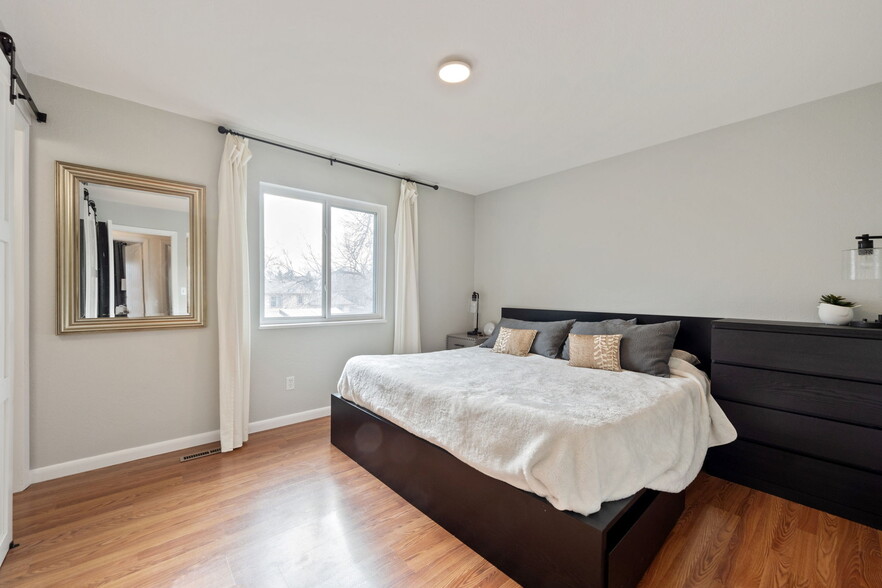 Main bedroom with large windows and closet space. - 3418 Stratton Dr