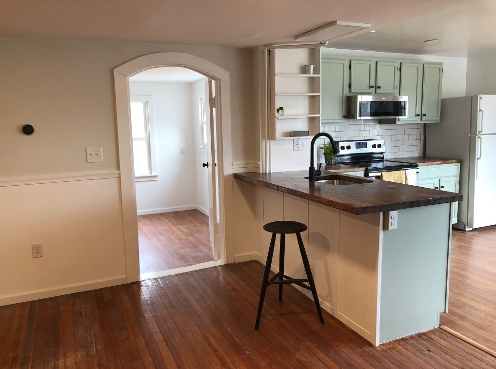 main room: next to kitchen, entry to lower bedroom, full bathroom and stairs. - 11 Waterside Ln