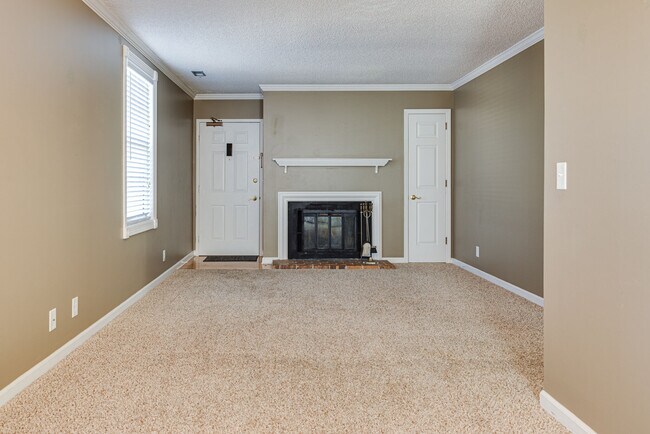 The living room offers a fireplace and coat closet - 760 Fox Ridge Dr