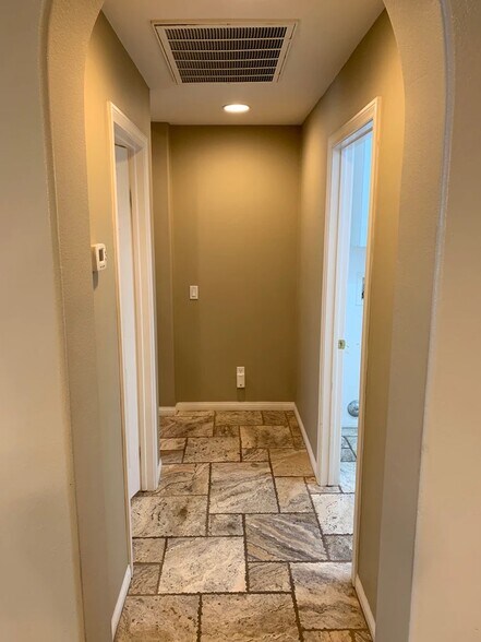 Hall to bathroom on left and laundry room on right. Primary bedroom around the corner. - 84126 Canzone Dr
