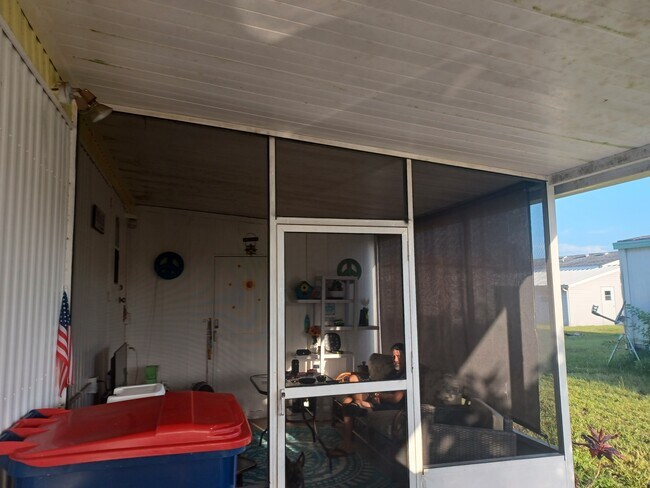 LANAI AT END OF CARPORT - PARKING FOR 2 VEHICLES - 7325 Demure Ln