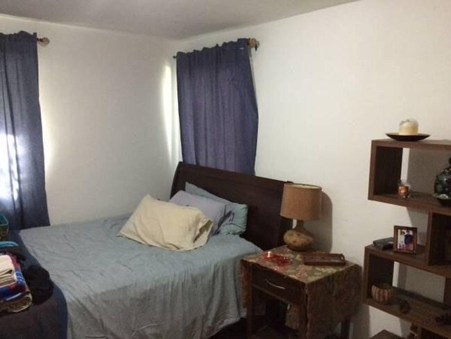 Bedroom with previous tenant furniture - 3829 Davis Pl NW
