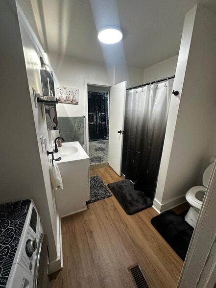 recently renovated bathroom with new toilet, vanity, and floors - 264 Hamilton St