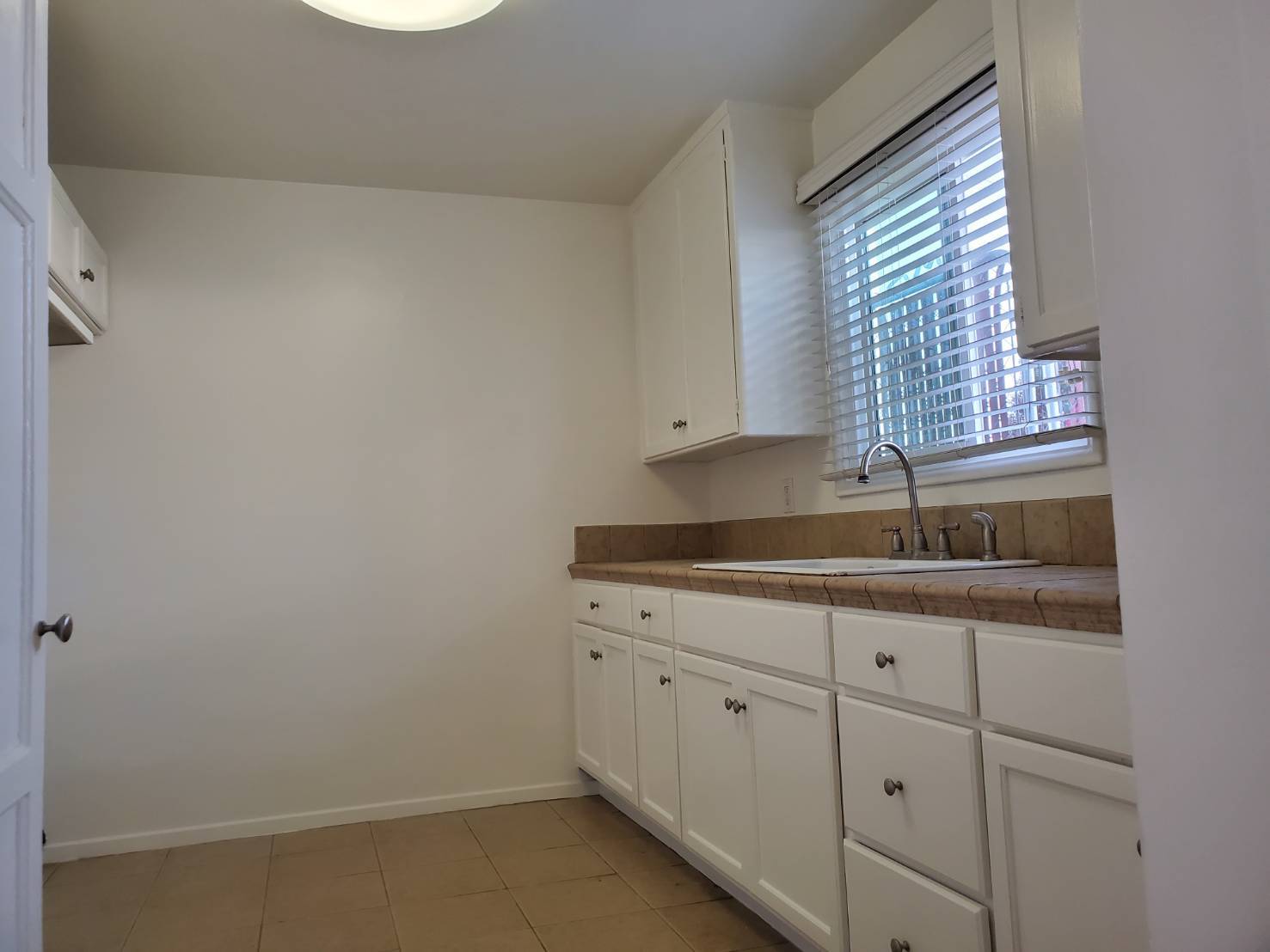 Kitchen with large cabinets and tile flooring - 4138 Redondo Beach Blvd