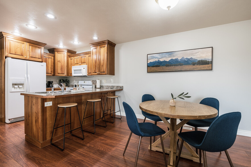 Dining space with table, chairs, and bar stools - 406 Neff Cir