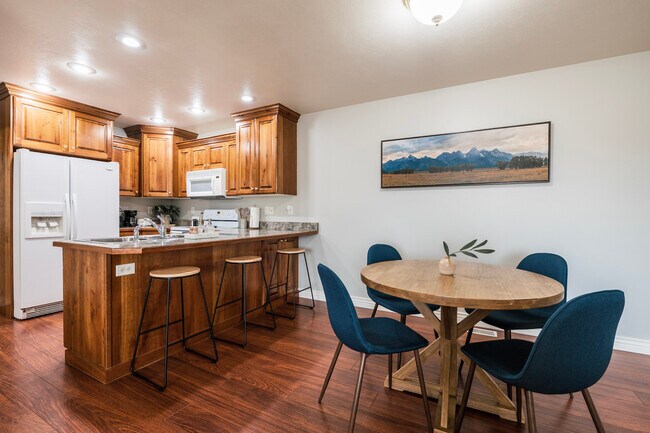 Dining space with table, chairs, and bar stools - 406 Neff Cir