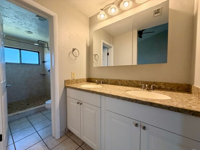 Building Photo - Light-Filled 2BR Condo in Gated Pelican Bay Near Golf, Beach & I-95