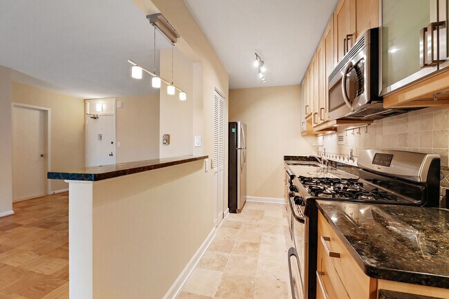 Building Photo - Spacious, and Sunlit 1 BD/1 BA Condo w/Reserved Garage Parking and Utilities Included in Chevy Ch...