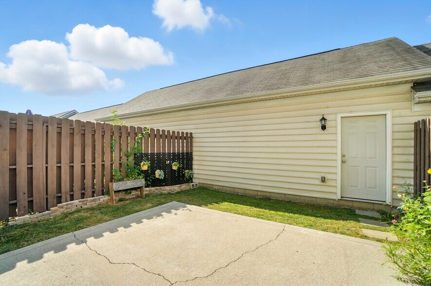 Private patio and yard with access to garage - 6169 Needletail Rd