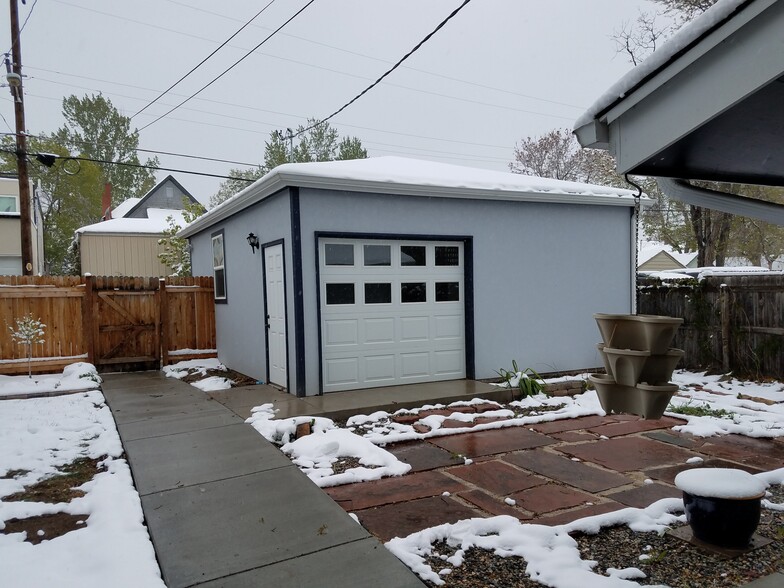 Two-car detached garage in back yard with patio and second interior-facing garage door great for entertaining - 3927 Tejon St