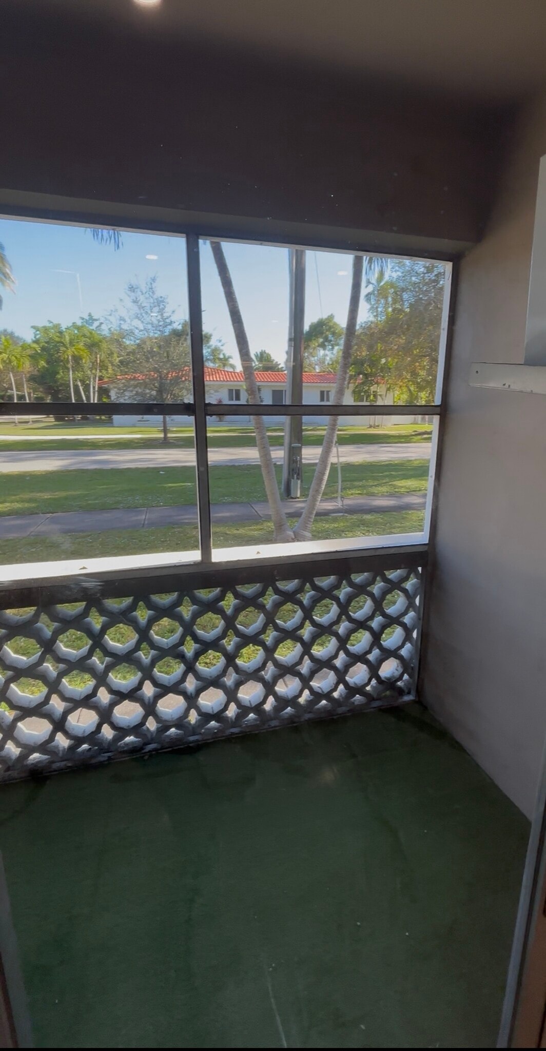 Screened patio looking at tree lined neighborhood street - 6580 Santona St