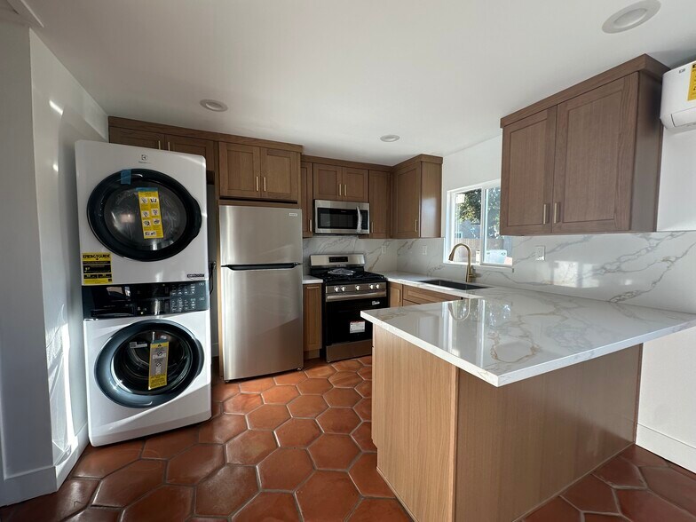 Kitchen with all new appliances installed and included. - 8409 Adoree St