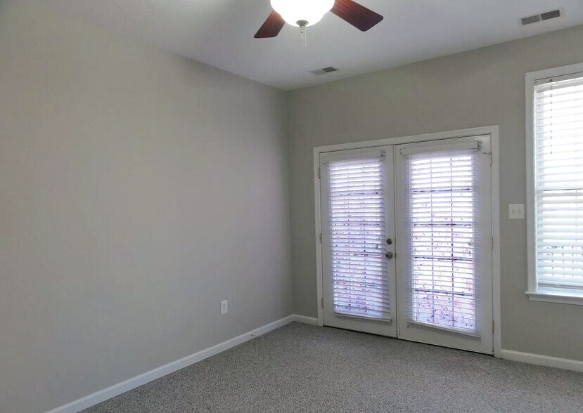 Grand bedroom with french doors to outside deck and yard - 334 Lora Dr