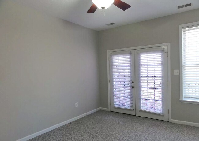Grand bedroom with french doors to outside deck and yard - 334 Lora Dr