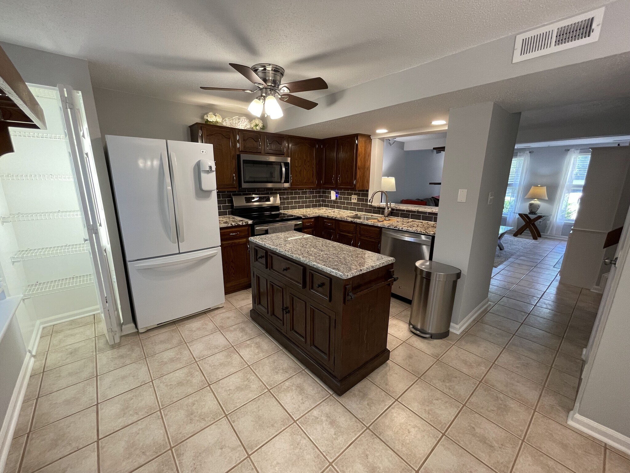 Kitchen with movable center island - move over when cooking and need the counter space, move out of - 4204 Whistler Ct