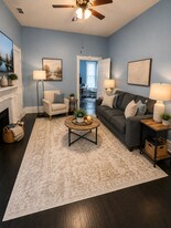 Bright furnished living room with historic fireplace and Smart TV - 319 W 33rd St
