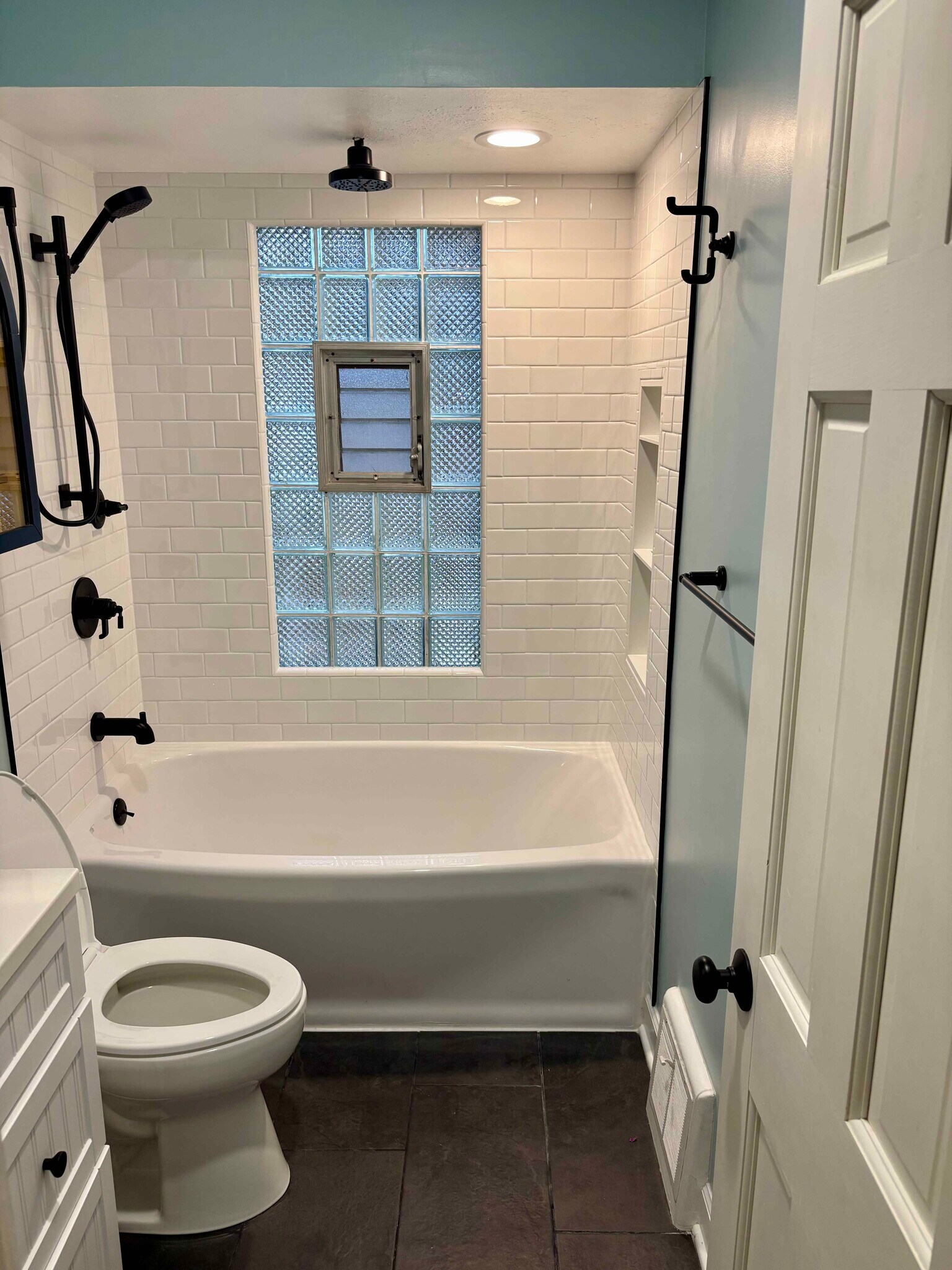 Newly renovated bathroom with new tub, shower, tile, and toilet (2025) - 3276 S Lenox St